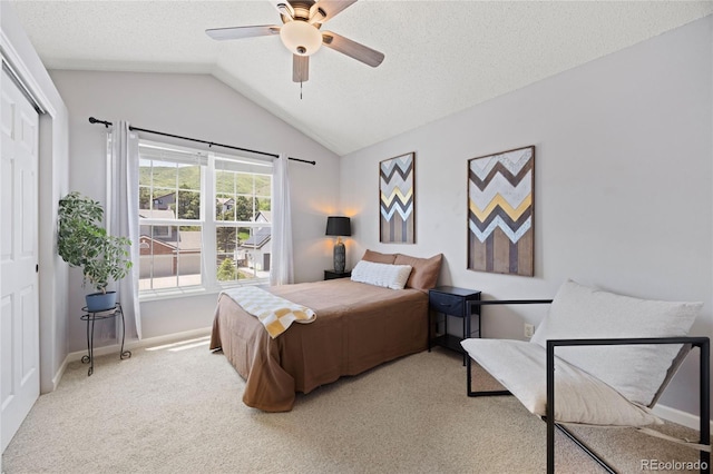 10 Sand Cherry, Littleton, CO 80127 - carpeted bedroom with lofted ceiling, baseboards, a closet, a ceiling fan, and a textured ceiling