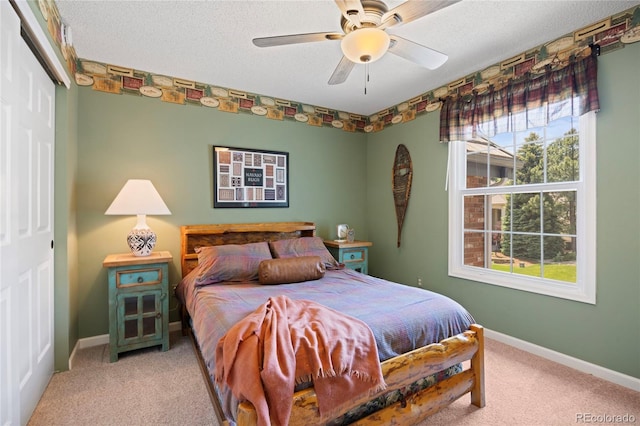 10 Sand Cherry, Littleton, CO 80127 - bedroom featuring a closet, carpet, baseboards, a ceiling fan, and a textured ceiling