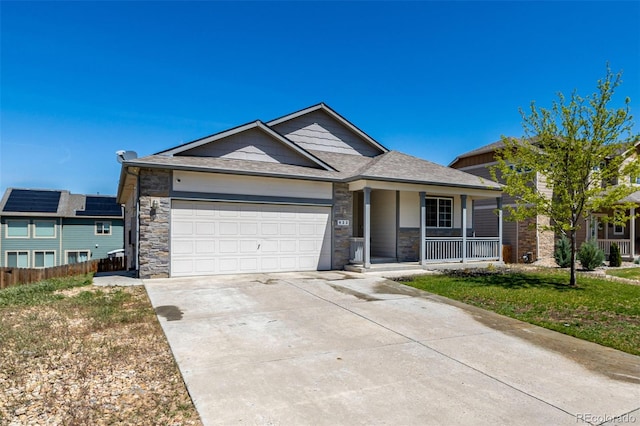 933 W Independent Ave, La Salle, CO 80645 - ranch-style home featuring a garage, fence, covered porch, stone siding, and driveway