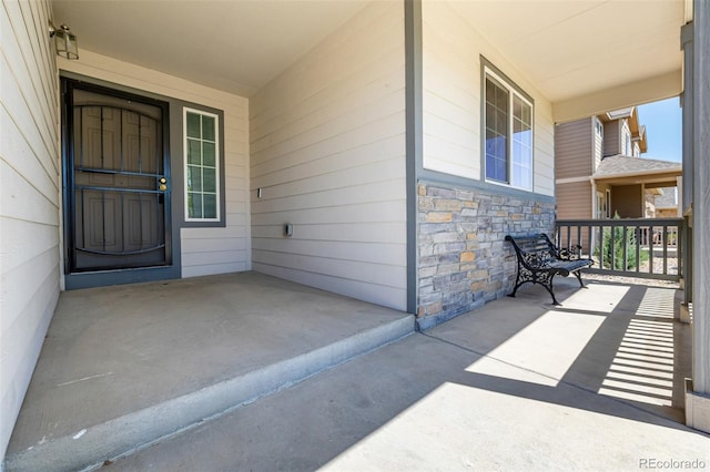 933 W Independent Ave, La Salle, CO 80645 - property entrance featuring covered porch and stone siding