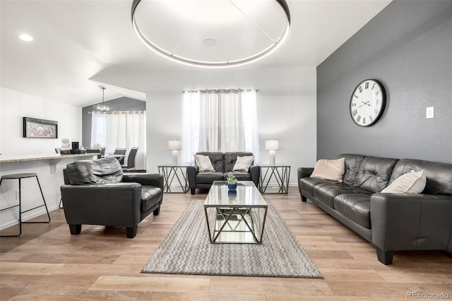 933 W Independent Ave, La Salle, CO 80645 - living area featuring an inviting chandelier, baseboards, light wood-style flooring, and lofted ceiling