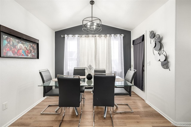 933 W Independent Ave, La Salle, CO 80645 - dining room with an inviting chandelier, baseboards, vaulted ceiling, and wood finished floors