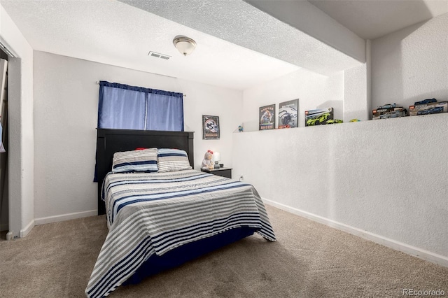 933 W Independent Ave, La Salle, CO 80645 - bedroom with carpet floors, a textured wall, visible vents, and baseboards