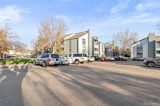uncovered parking lot featuring a residential view