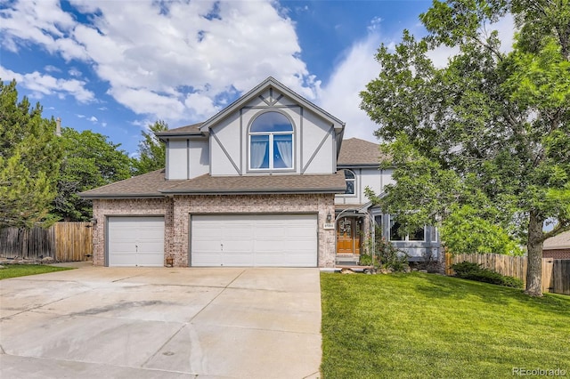6588 S Oak Cir, Littleton, CO 80127 - tudor home with concrete driveway, stucco siding, roof with shingles, and an attached garage