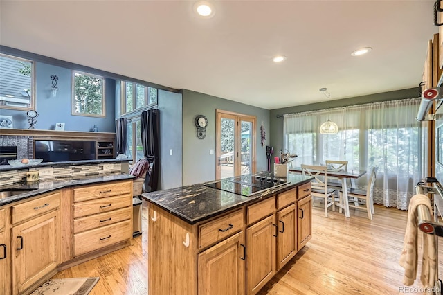 6588 S Oak Cir, Littleton, CO 80127 - kitchen featuring black electric stovetop, a kitchen island, light wood-type flooring, recessed lighting, and pendant lighting