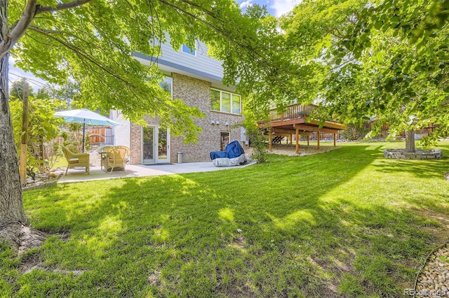 6588 S Oak Cir, Littleton, CO 80127 - view of green lawn featuring a patio and a deck
