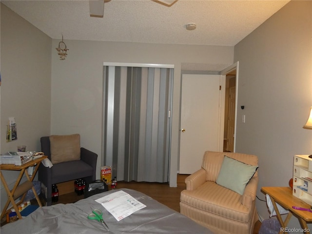 bedroom featuring wood finished floors and a textured ceiling