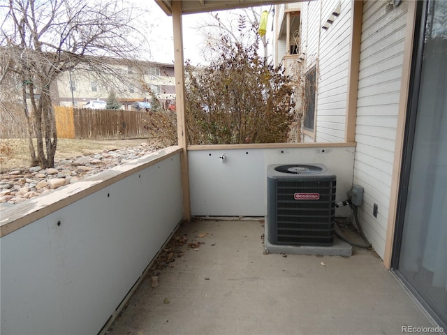 view of patio featuring central AC unit and a balcony