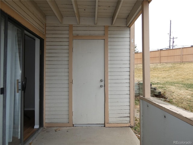 view of exterior entry with fence