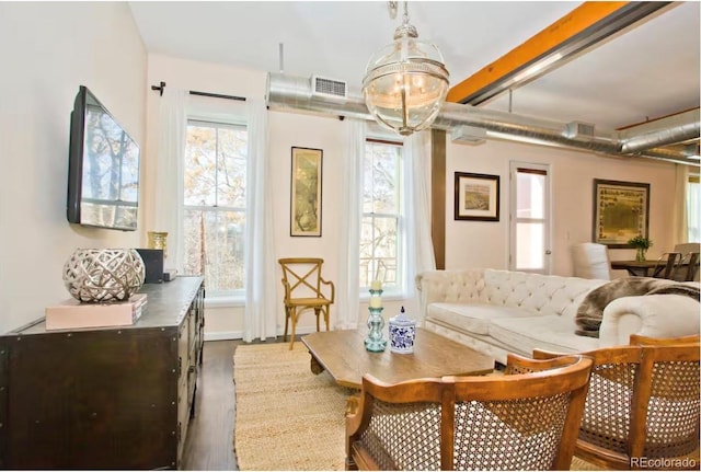 sitting room featuring dark wood-type flooring and visible vents