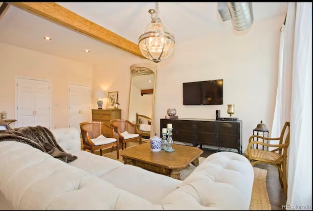 living area featuring beam ceiling and recessed lighting