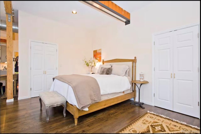 bedroom with recessed lighting, wood finished floors, baseboards, a closet, and beam ceiling