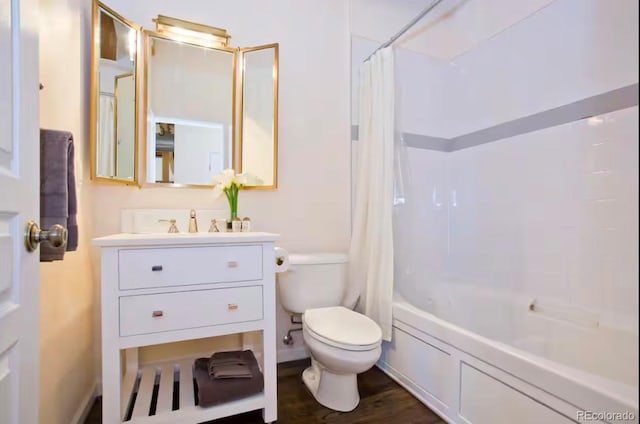 full bath featuring toilet, shower / bath combo, wood finished floors, and vanity