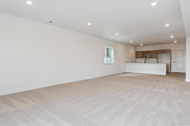 unfurnished living room with light carpet