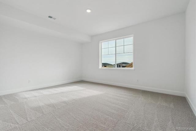 unfurnished room featuring light colored carpet