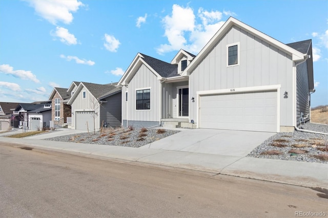modern farmhouse featuring concrete driveway, an attached garage, and board and batten siding