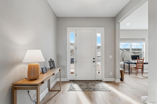 foyer featuring wood finished floors, baseboards, and recessed lighting