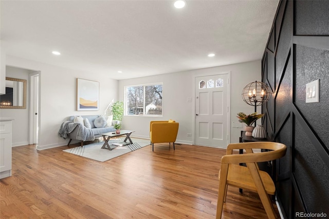 sitting room with baseboards, recessed lighting, and light wood-style floors