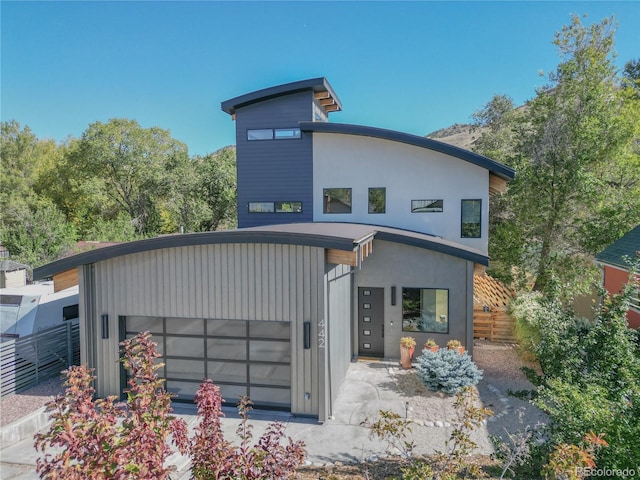 contemporary house with a garage and fence