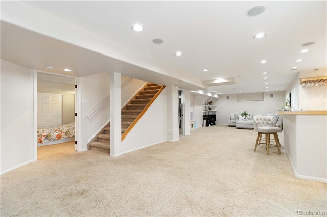 9169 Fox Fire Way, Highlands Ranch, CO 80129 - living room featuring light carpet, recessed lighting, baseboards, and stairs