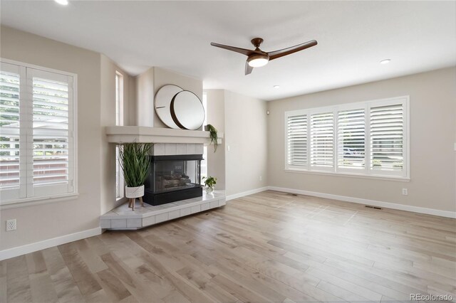 9169 Fox Fire Way, Highlands Ranch, CO 80129 - unfurnished living room with a ceiling fan, healthy amount of natural light, wood finished floors, baseboards, and recessed lighting