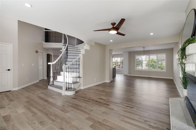 9169 Fox Fire Way, Highlands Ranch, CO 80129 - unfurnished living room featuring stairs, a ceiling fan, light wood-style flooring, recessed lighting, and baseboards