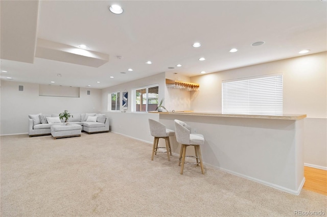 9169 Fox Fire Way, Highlands Ranch, CO 80129 - living room featuring recessed lighting, light carpet, baseboards, and bar