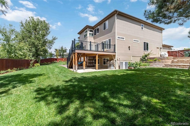 9169 Fox Fire Way, Highlands Ranch, CO 80129 - rear view of property featuring a wooden deck, central AC unit, stairway, and a patio