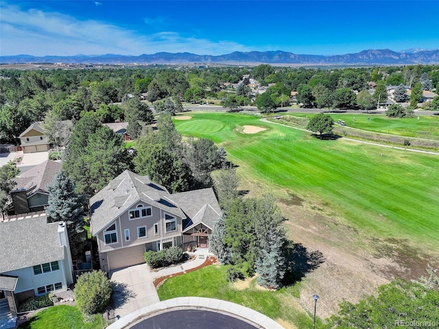 bird's eye view with view of golf course and a mountain view