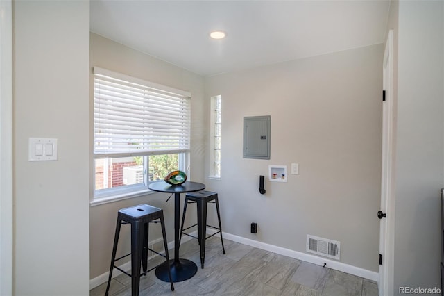 laundry room featuring electric panel, visible vents, baseboards, and hookup for a washing machine