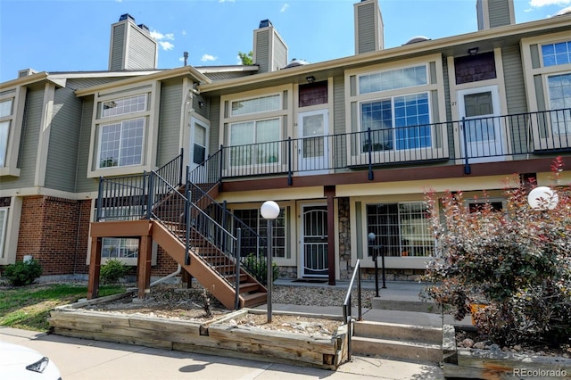 1885 S Quebec Way Unit A16, Denver, CO 80231 - view of front of house featuring a chimney and stairway