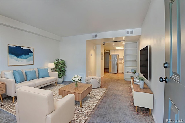 1885 S Quebec Way Unit A16, Denver, CO 80231 - living area featuring light carpet and track lighting