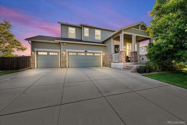 12972 Uinta Ct, Thornton, CO 80602 - view of front facade featuring concrete driveway, covered porch, stone siding, and a garage