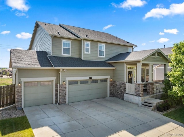 12972 Uinta Ct, Thornton, CO 80602 - view of front of house with concrete driveway, a porch, stone siding, and roof with shingles