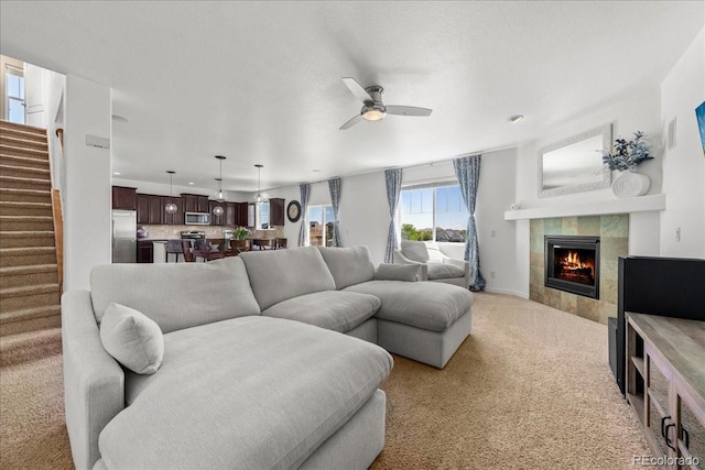 12972 Uinta Ct, Thornton, CO 80602 - carpeted living room with a ceiling fan, a fireplace, stairs, and recessed lighting