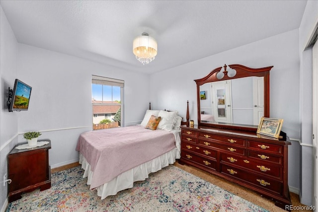 12972 Uinta Ct, Thornton, CO 80602 - carpeted bedroom with baseboards and a chandelier