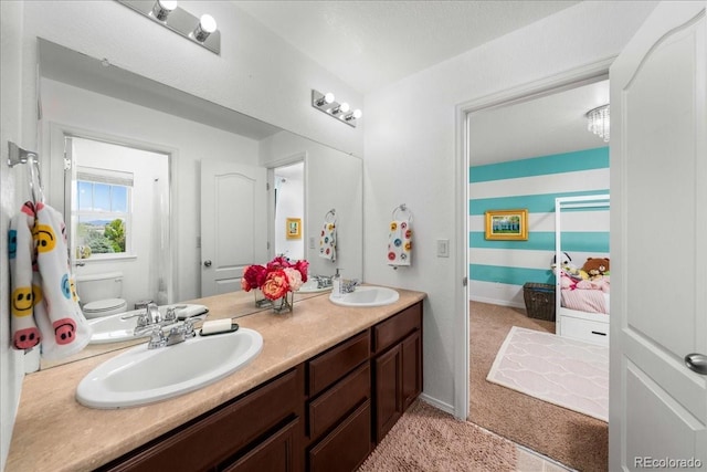 12972 Uinta Ct, Thornton, CO 80602 - bathroom with toilet, double vanity, and baseboards