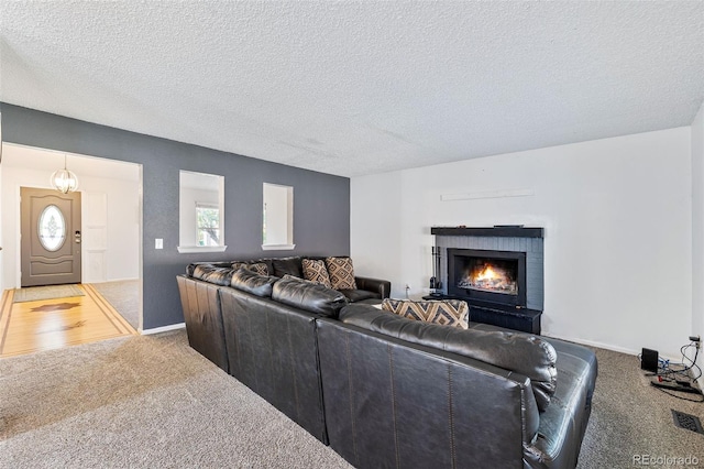 9805 Garrison Ct, Broomfield, CO 80021 - living room with light colored carpet, a textured ceiling, a fireplace, and baseboards