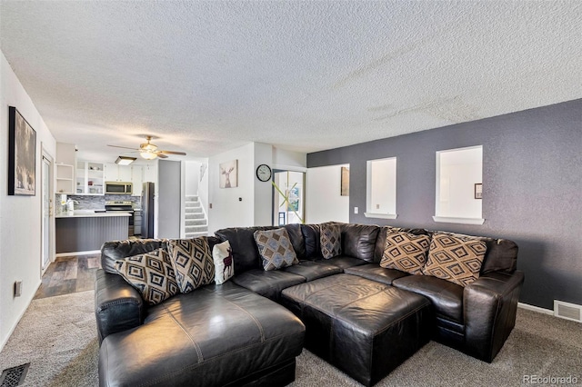 9805 Garrison Ct, Broomfield, CO 80021 - carpeted living area featuring a textured ceiling, stairs, a ceiling fan, a sink, and baseboards