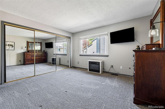 9805 Garrison Ct, Broomfield, CO 80021 - unfurnished bedroom with carpet, a closet, a textured ceiling, heating unit, and baseboards