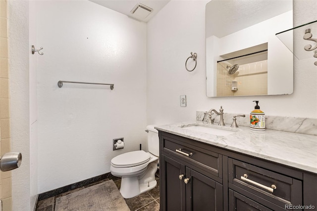 9805 Garrison Ct, Broomfield, CO 80021 - full bathroom with vanity, toilet, tile patterned floors, and a shower