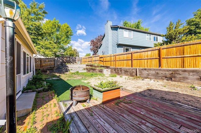 9805 Garrison Ct, Broomfield, CO 80021 - wooden deck with an outdoor fire pit and a fenced backyard