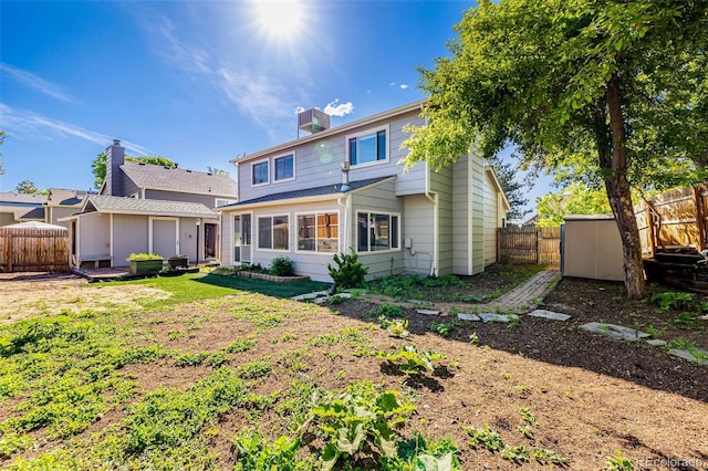 9805 Garrison Ct, Broomfield, CO 80021 - back of house with a fenced backyard and a chimney