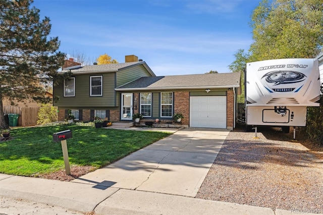 tri-level home featuring a garage and a front lawn