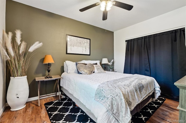 bedroom featuring hardwood / wood-style flooring and ceiling fan