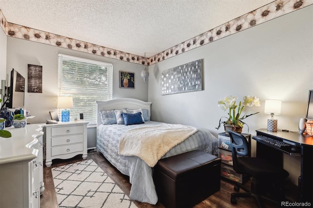 bedroom featuring hardwood / wood-style floors and a textured ceiling