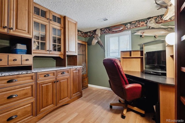 office space featuring light hardwood / wood-style floors and a textured ceiling