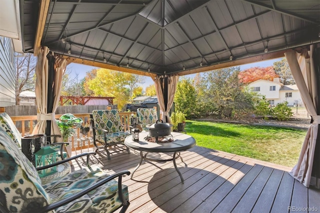 wooden deck featuring a gazebo and a yard