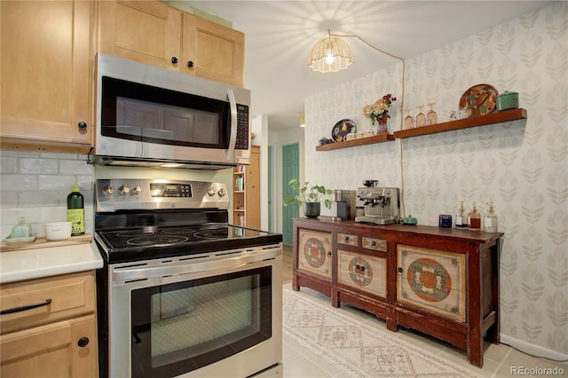 kitchen with light brown cabinetry, open shelves, stainless steel appliances, and wallpapered walls